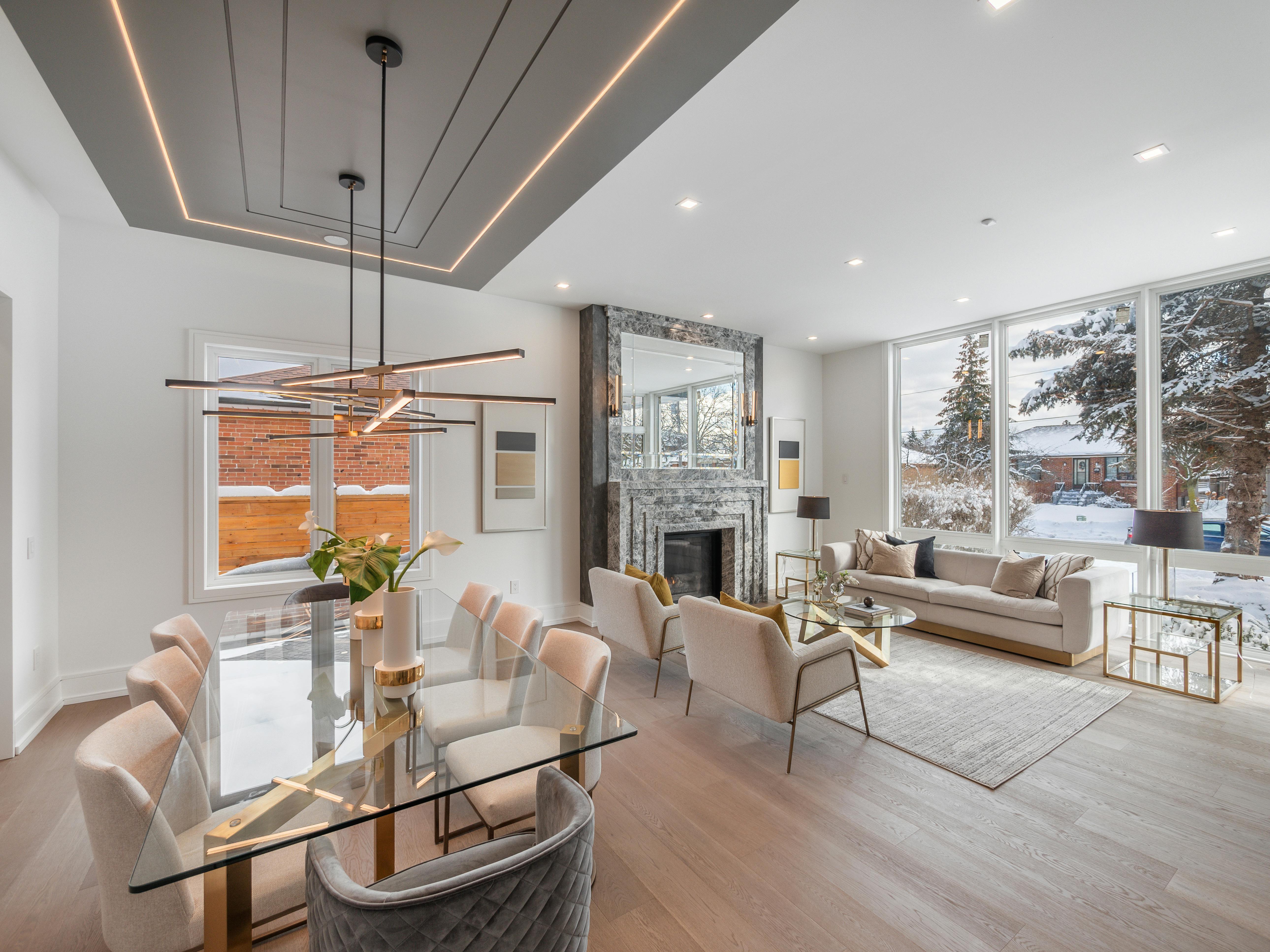 Spacious modern living room and dining area with elegant decor and a winter view in Toronto.