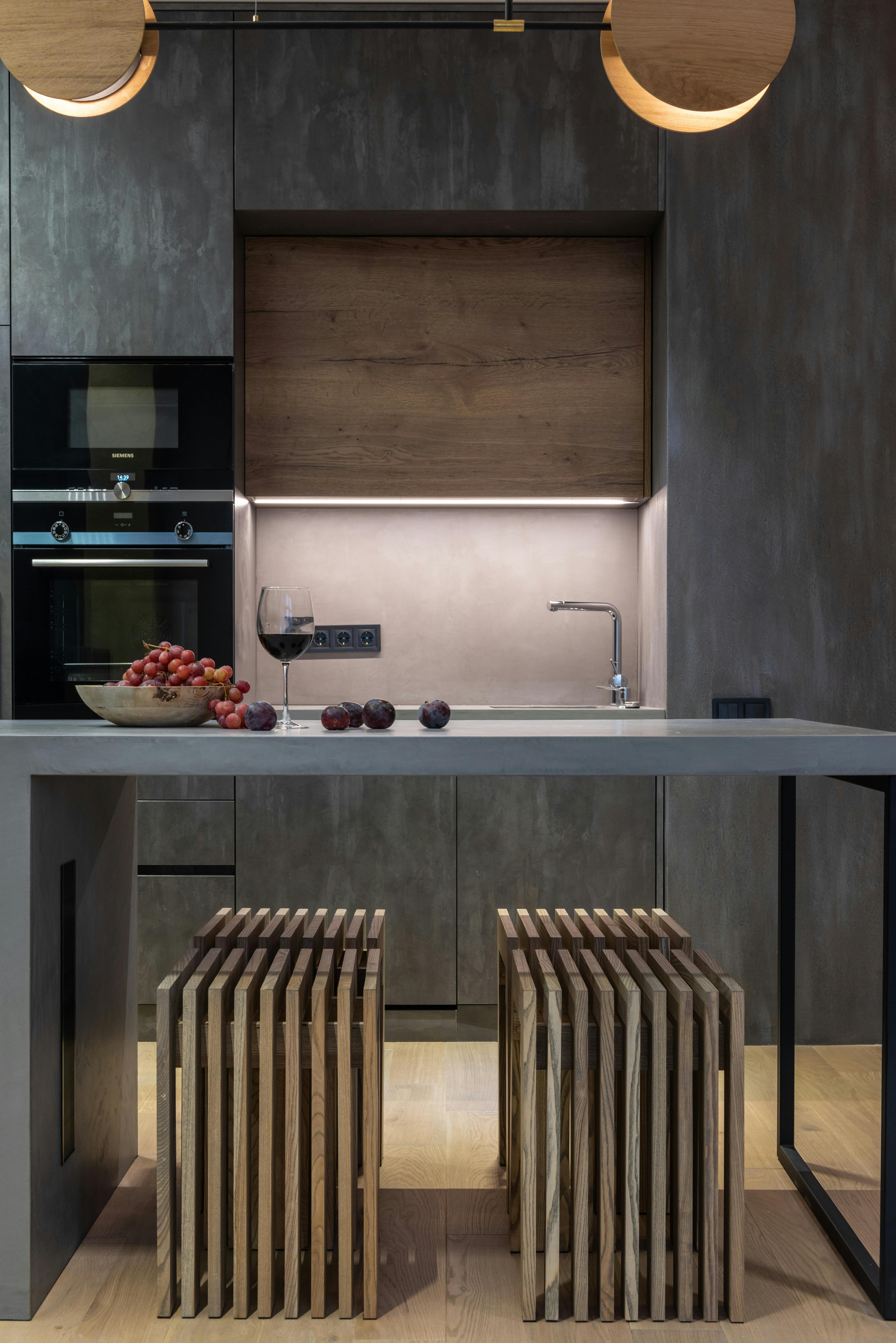 Contemporary kitchen space featuring a fruit bowl and wine, ideal for modern home design concepts.